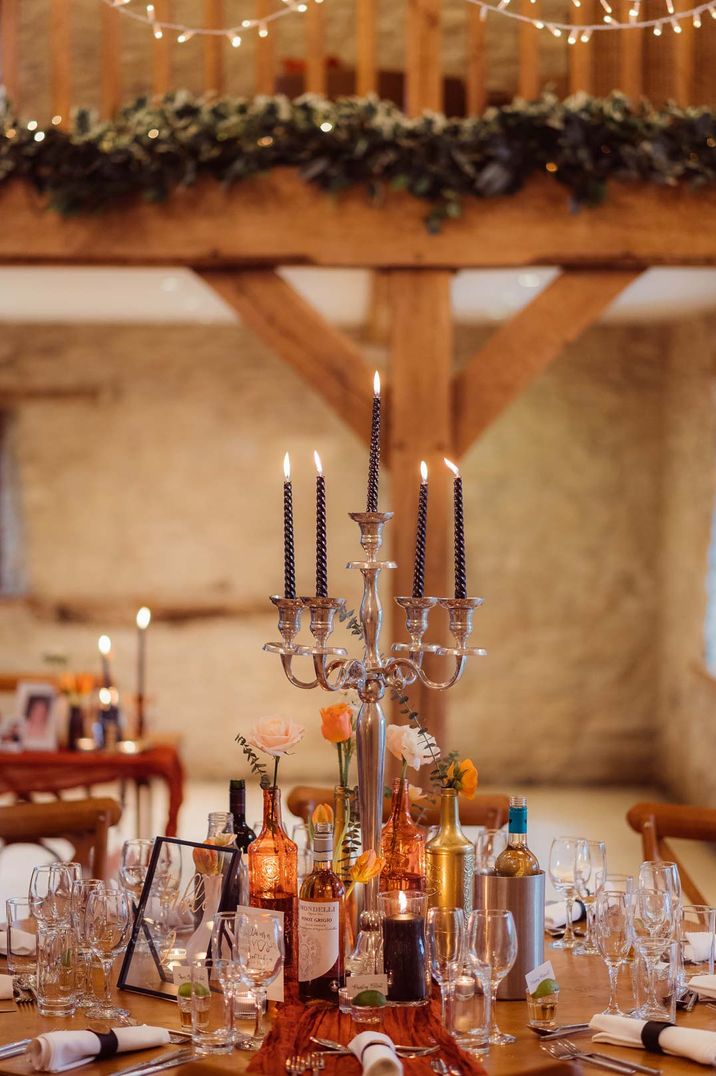 Kingscote Barn Tetbury wedding with rustic decorations and tall candelabra wedding table centrepiece 