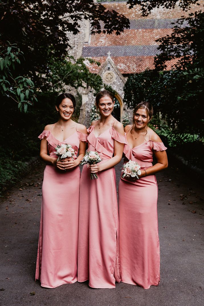 Bridesmaids in pink satin dresses for church wedding 