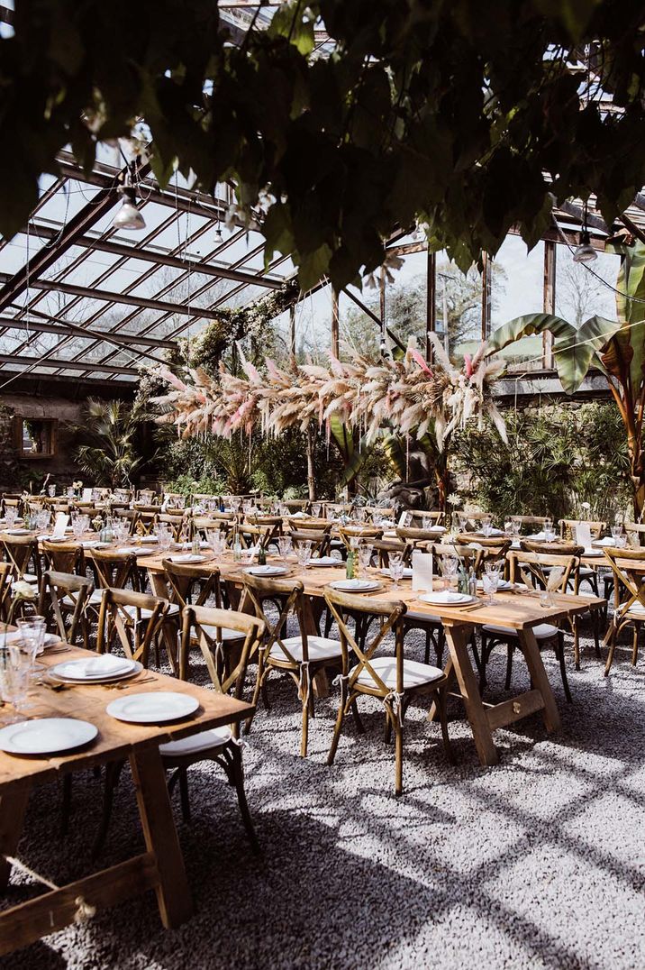 Anran glasshouse wedding venue decorated with huge colourful pampas grass wedding installation 