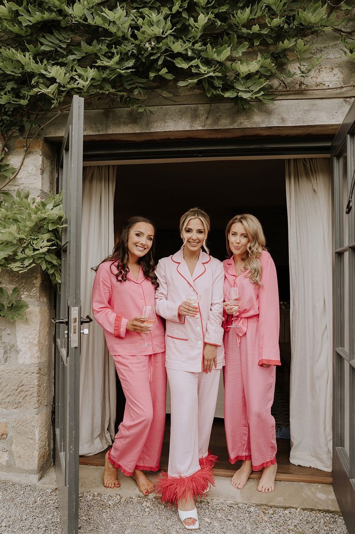 Bridal party wearing pink and red wedding pyjamas 