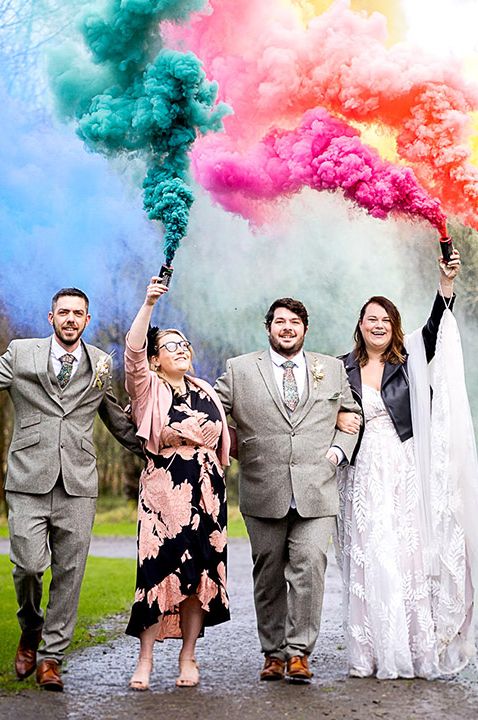 Colourful wedding smoke bomb photo of the wedding party wearing mismatched outfits 