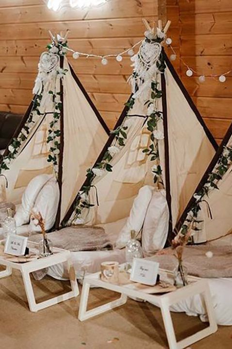 Mini tipi tents with pillows and blankets for kids to have naps and sleep on at the wedding 