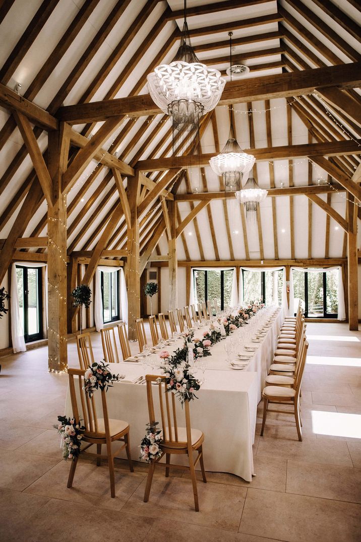 Intimate barn wedding reception with pink flowers 