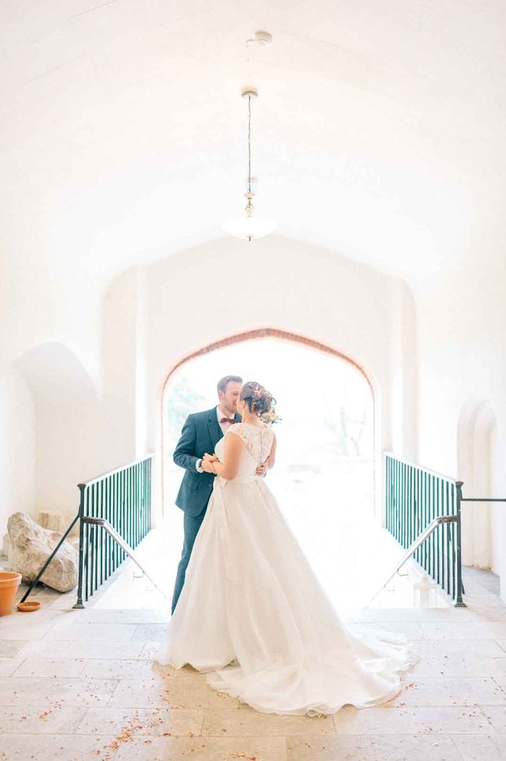 Bride in princess wedding dress dancing with groom at Farnham Castle London wedding venue 