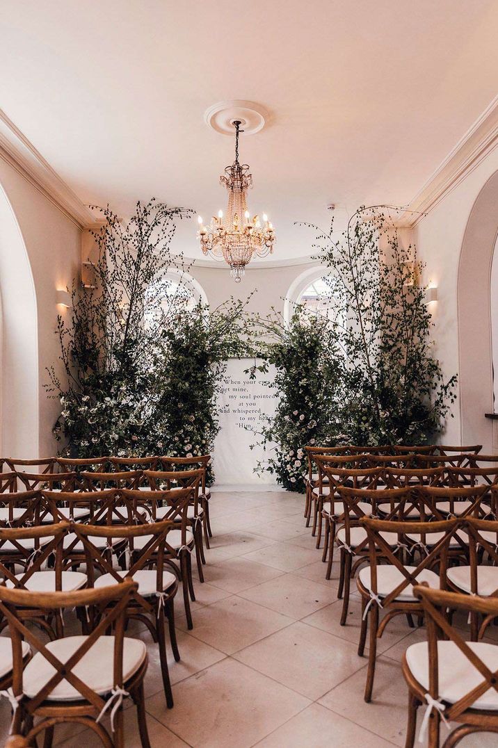 Greenery themed wedding - Iscoyd Park ceremony room with large chandelier and an abundance of large dried flower and foliage decorations