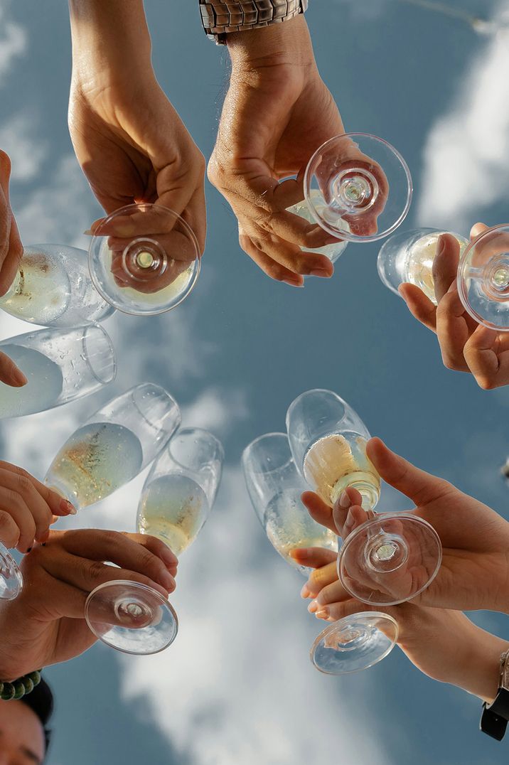 Stock image of a group of friends cheersing with prosecco outdoors