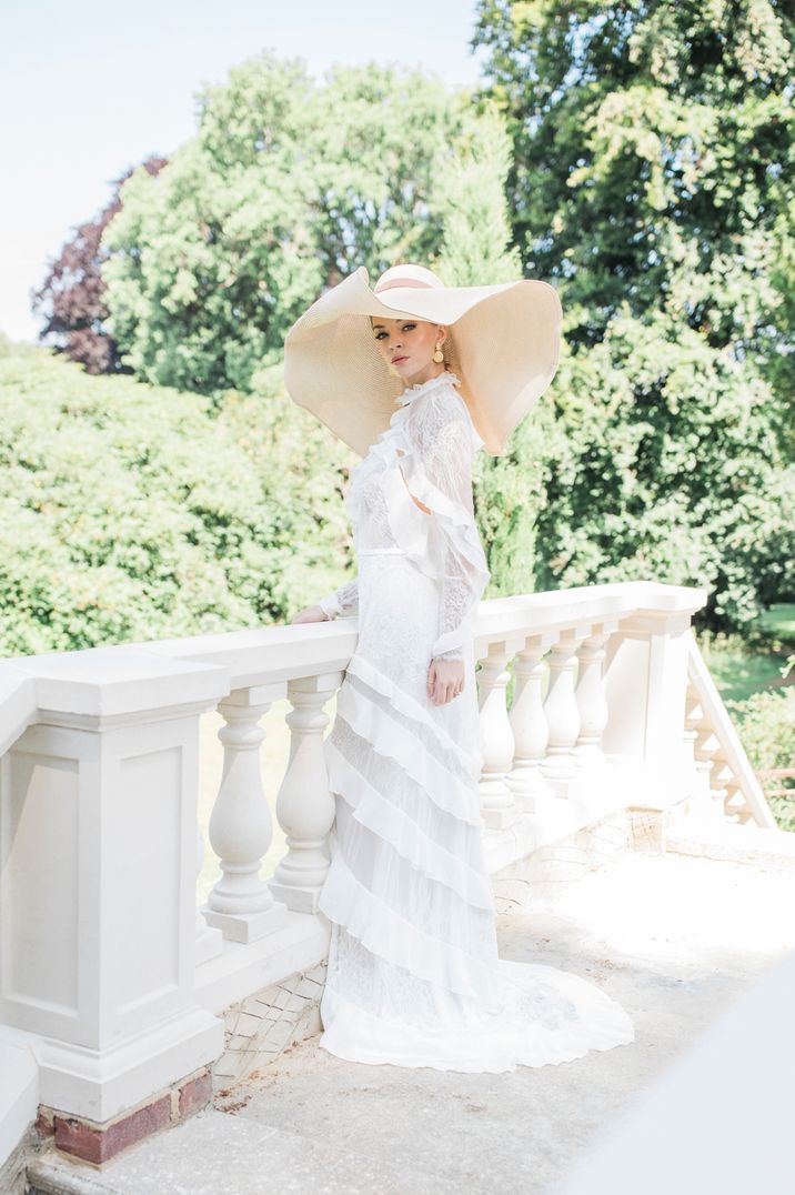 Bride Outdoors in Tasselled Wedding Dress With Straw Hat