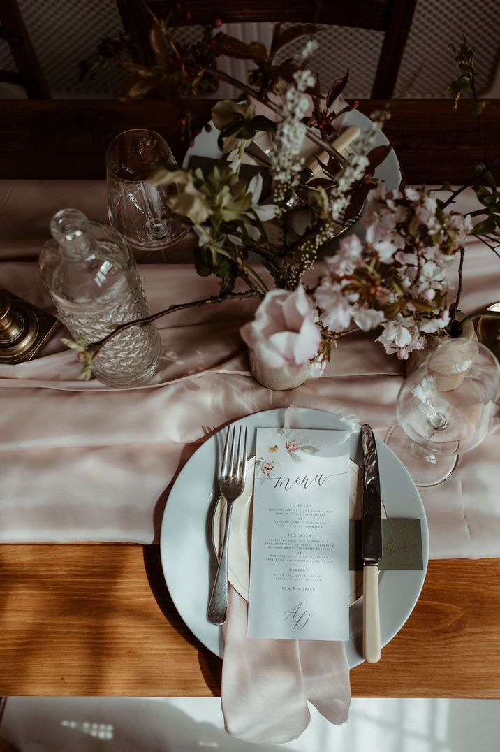 Light pink, white and silver wedding place setting for luxe dinner party