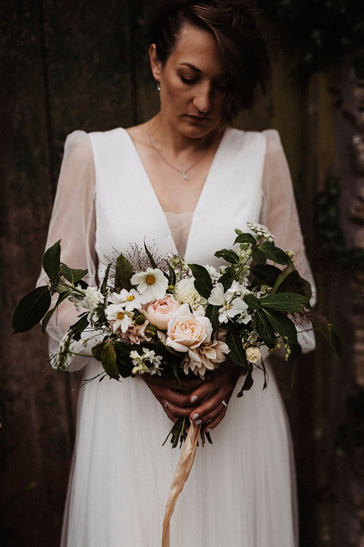 A romantic neutral tone wedding bouquet with cosmos inspired by birth flowers by month for October 