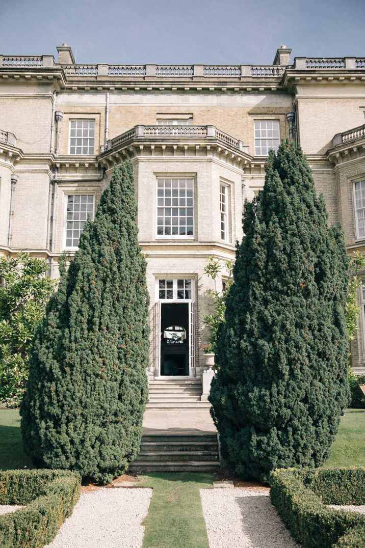 Hedsor Hall with large green trees