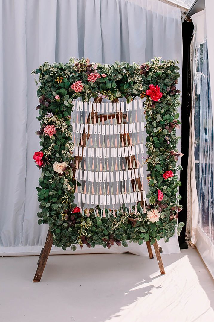 Hanging individual name place cards with flower decorations 