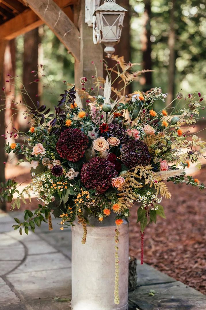 Textured wedding flower arrangement with dark hydrangeas with dried wedding grasses 