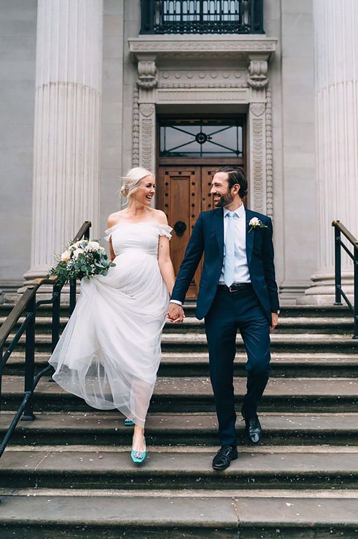 Pregnant bride and groom on their stairs at town hall elopement wedding