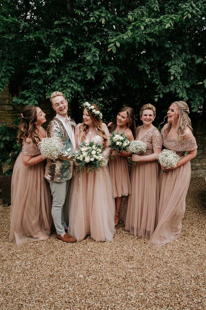 Mixed gender wedding party with bridesman in sequin jacket and bridesmaids in pink dresses