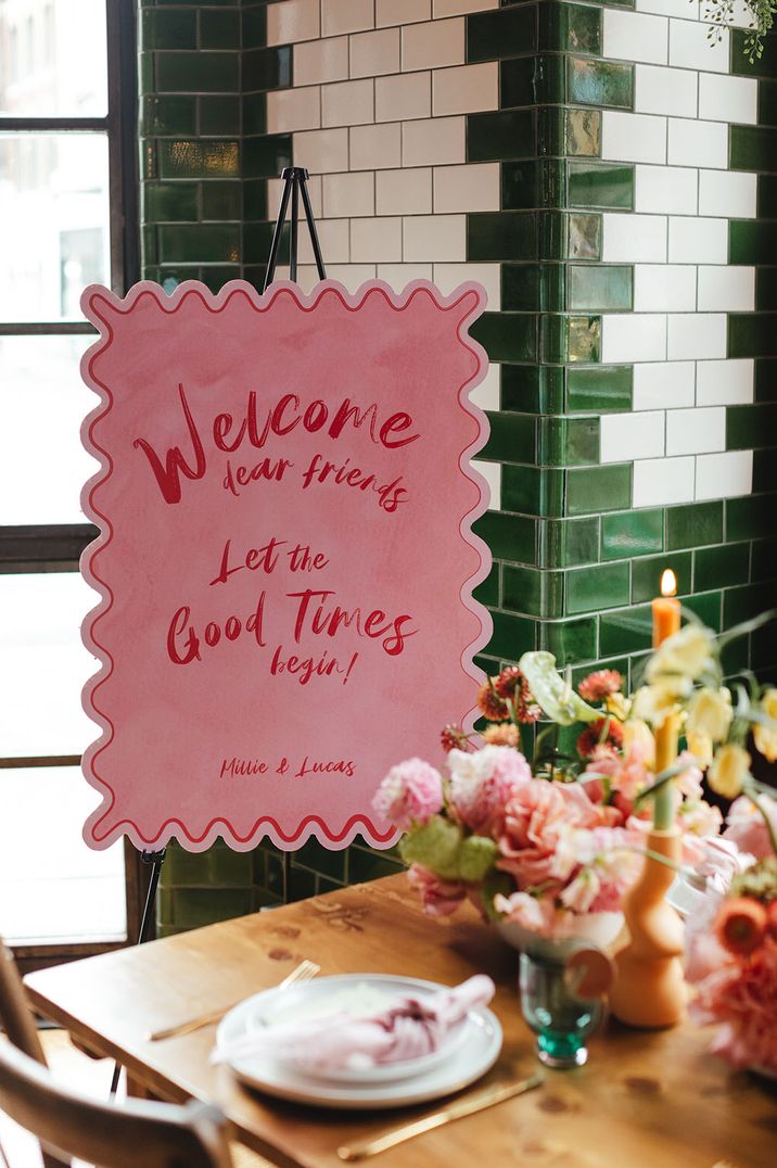 Pink and red funky wedding welcome sign with waved edges 