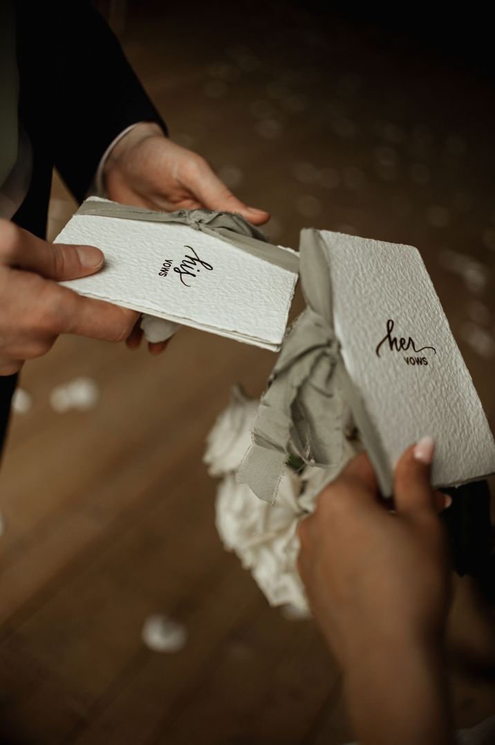 His and hers wedding vow booklet tied with light green ribbon 