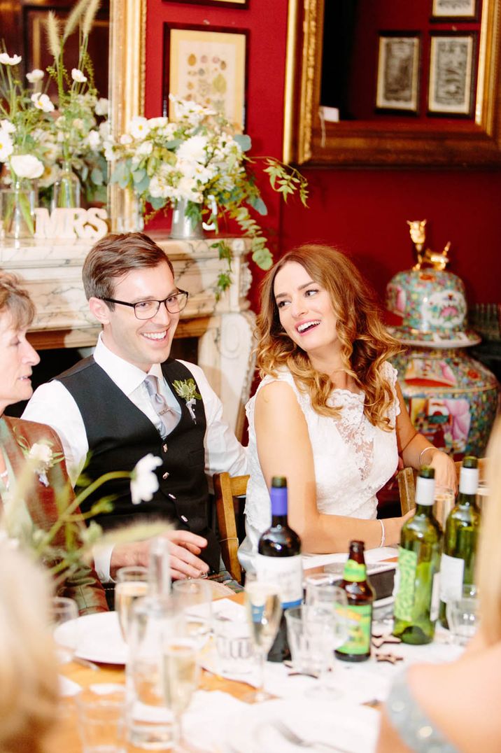 Bride and groom laughing during the wedding speeches at their Brunswick House