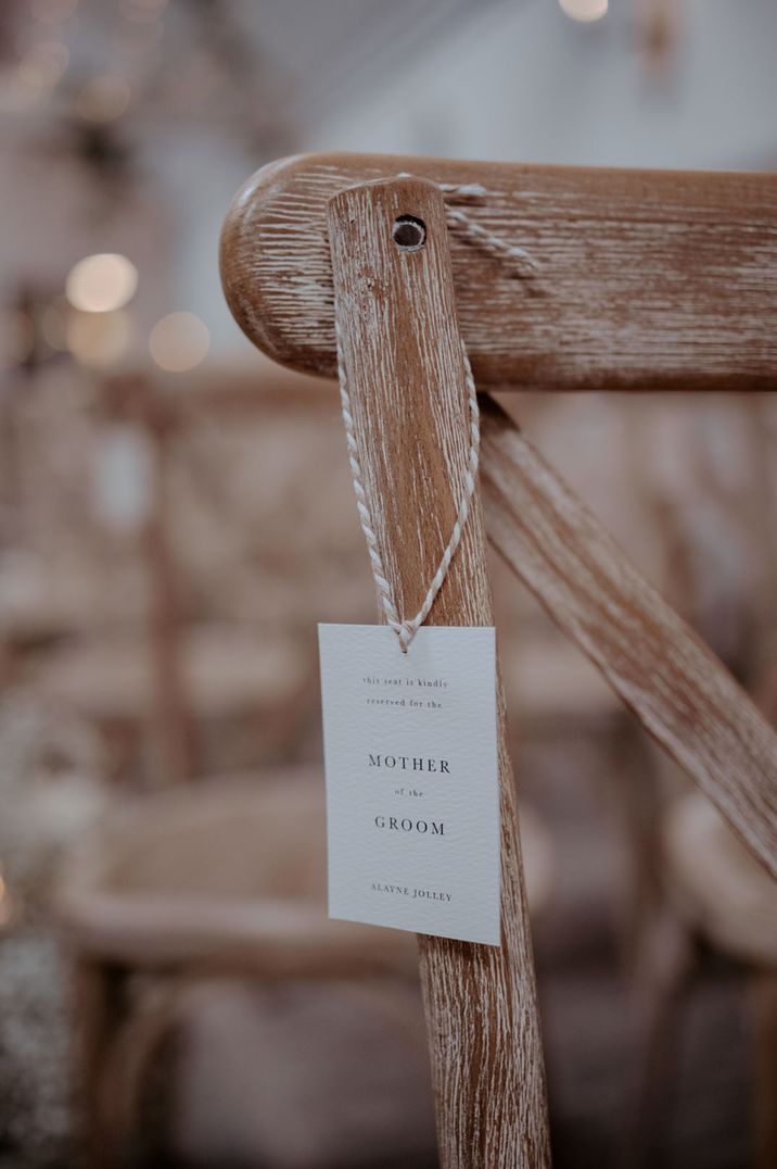 Simple and minimalist wedding seat reserved sign attached to the chair with string 