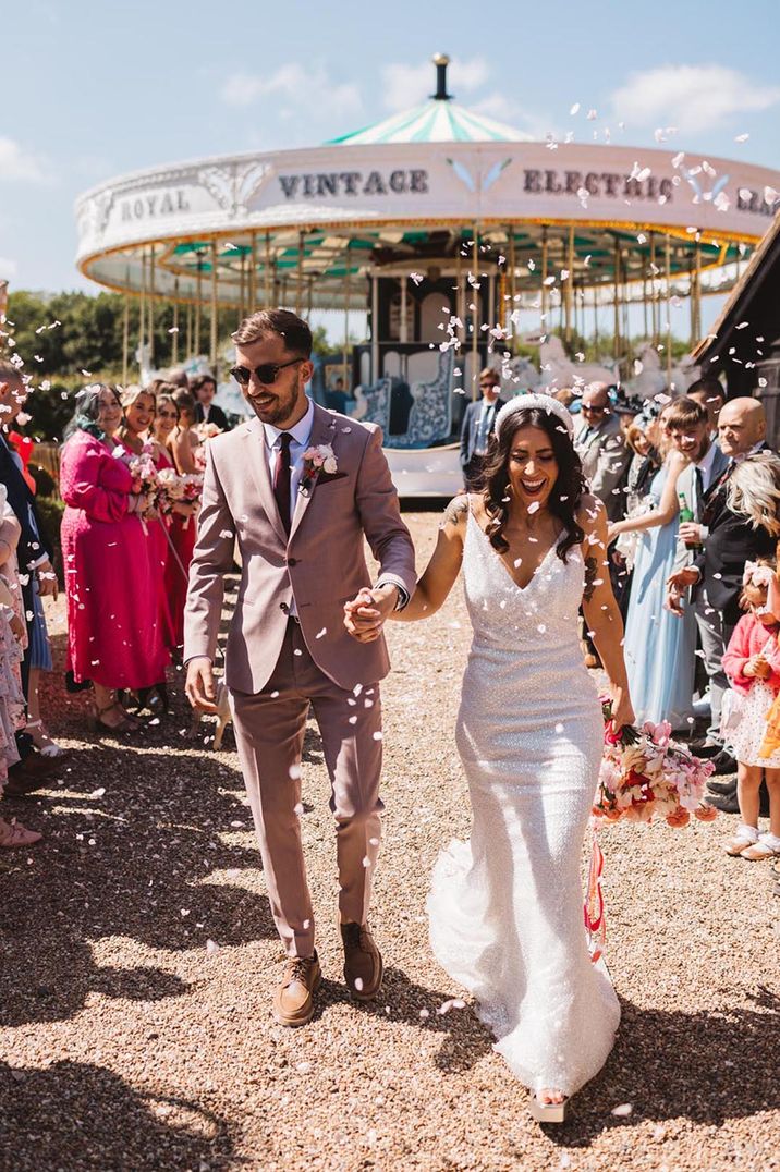 Preston Court fun fair wedding with bride in a sparkly wedding dress and headband and groom in a taupe suit 