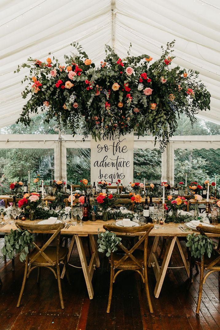 Wedding flower installation hanging above wedding tables at marquee wedding 