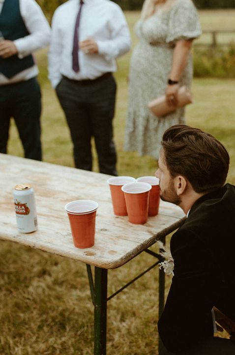 Game of beer pong for summer outdoor engagement party idea 