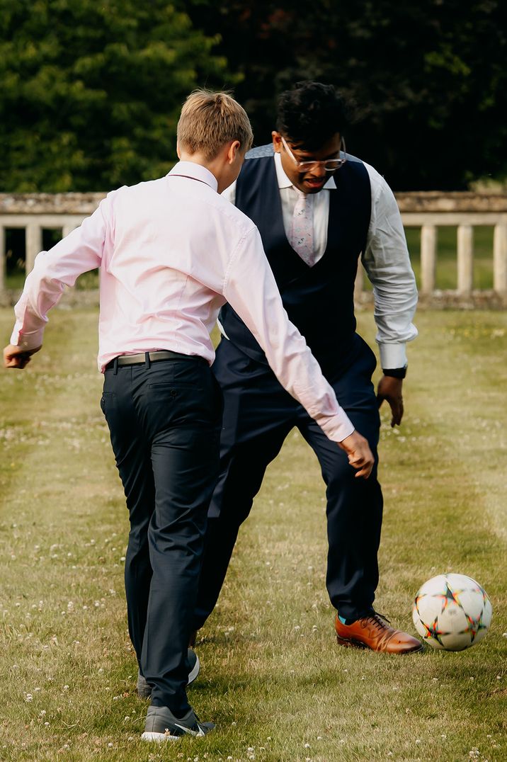 Groomsmen play football together for more relaxed and inexpensive stag do idea 