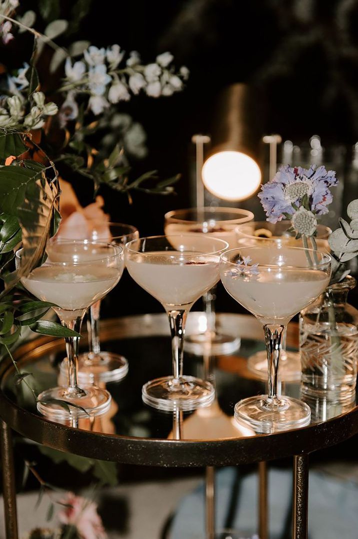 Cocktail glasses with edible flower decorations 