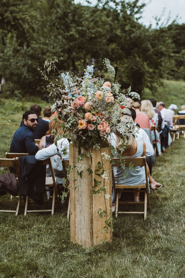 Outdoor boho wedding in Devon with colourful ceremony flowers 