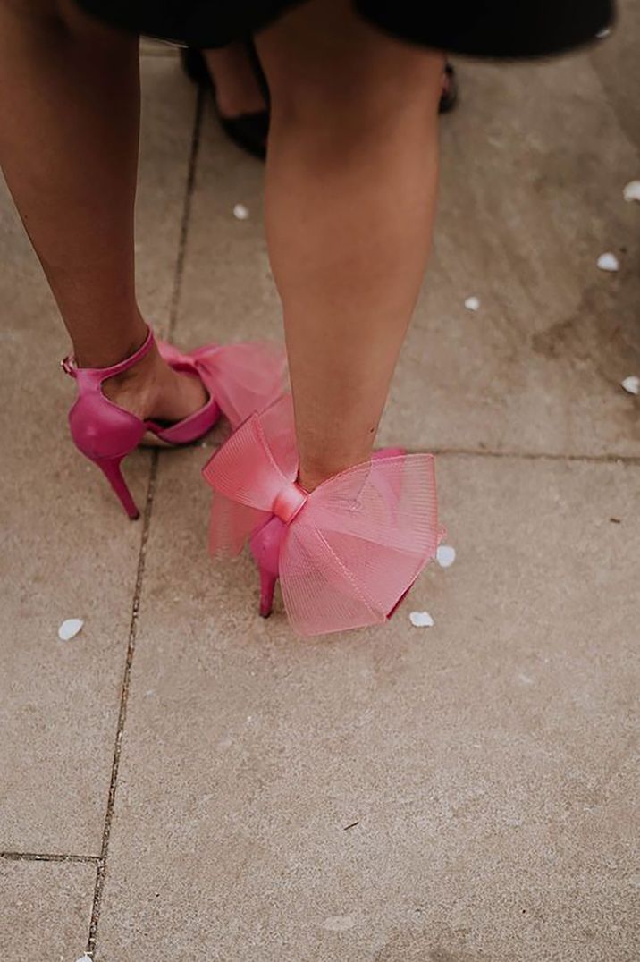 Person wearing pink bow heel shoes with oversized mesh bow on the back of the shoes by Georgina Harrison Photography