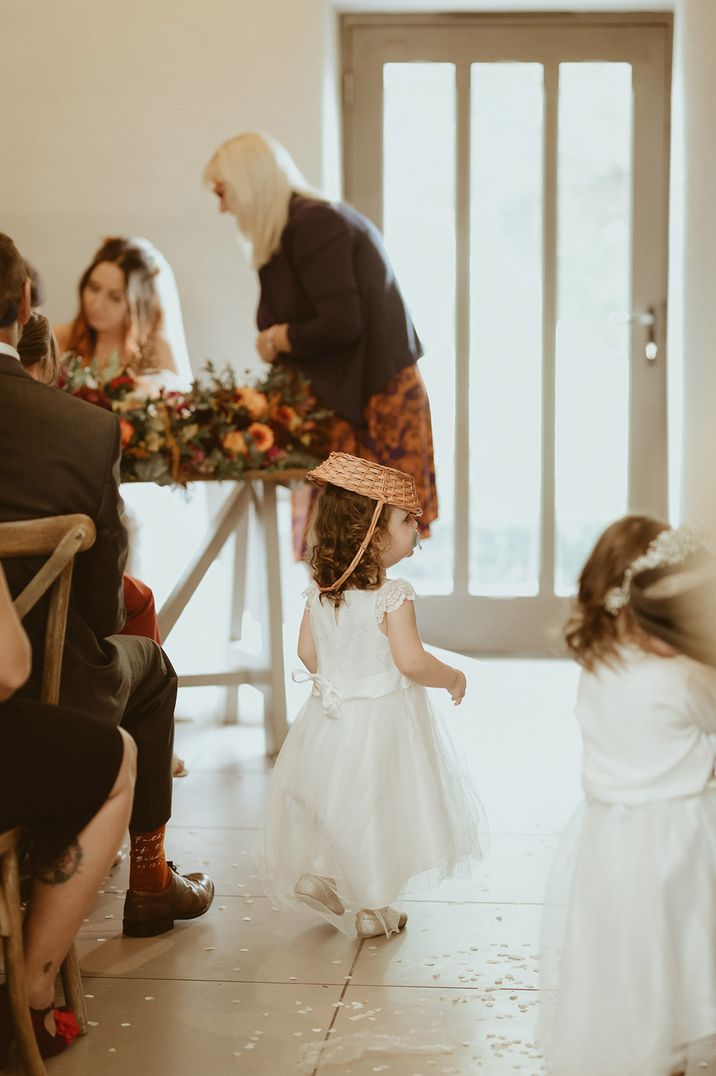 Flower girl fail with little girl walking around with the wicker basket on her head 