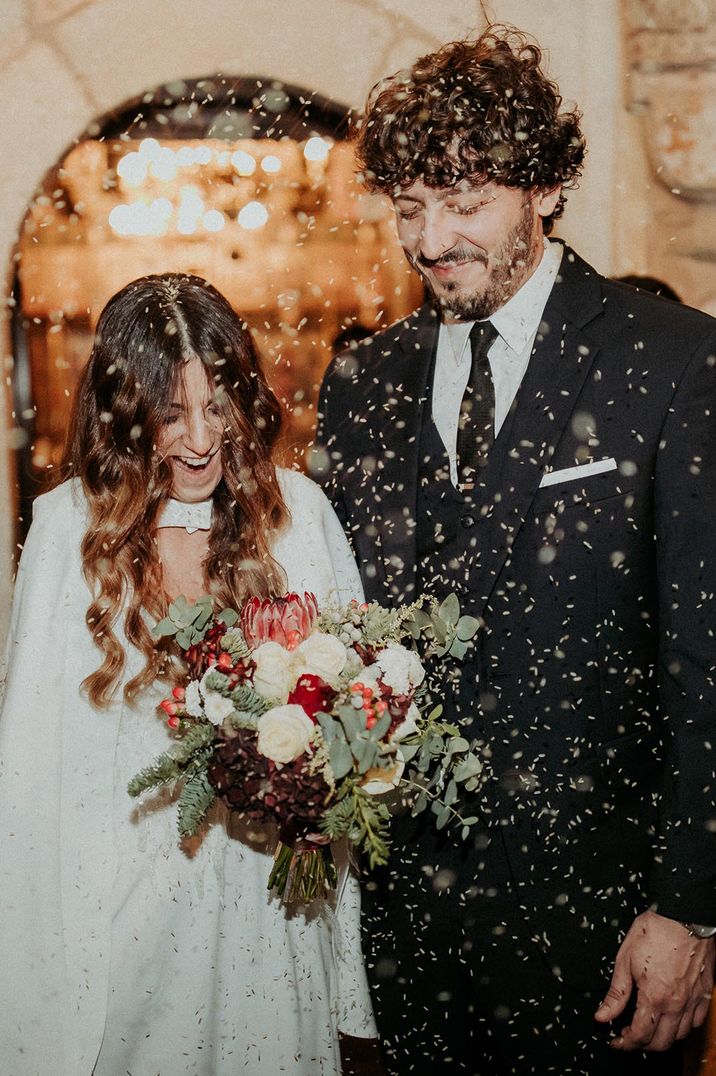 Bride and groom have a confetti exit from their winter wedding 