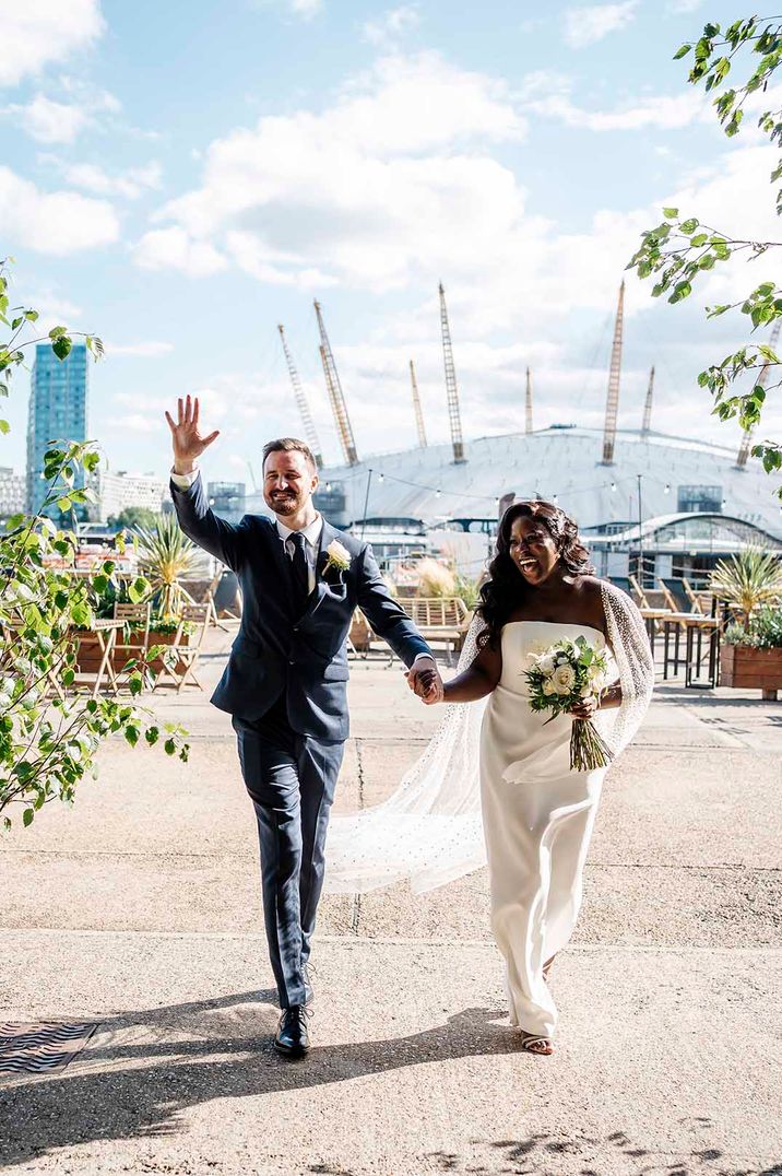 Trinity Buoy Wharf wedding with Black bride in a Halfpenny London wedding dress and Jesus Peiro bridal cape