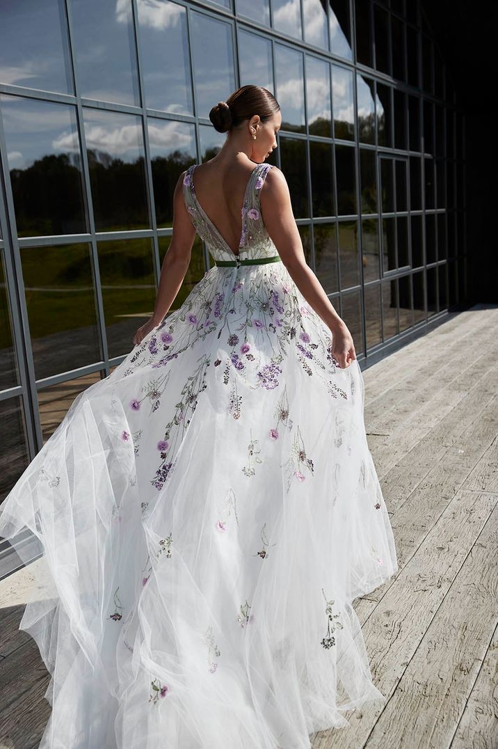 Bride in colourful sparkling embroidered wedding dress by Sassi Holford 