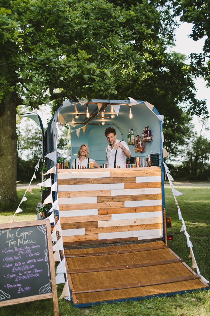 Outdoor wedding bar with bunting and festoon lighting decorations 