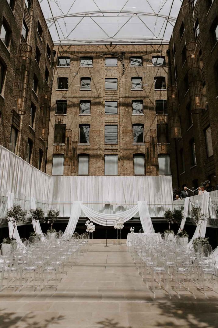 Devonshire terrace wedding venue in London - white wedding drapes and clear chairs 