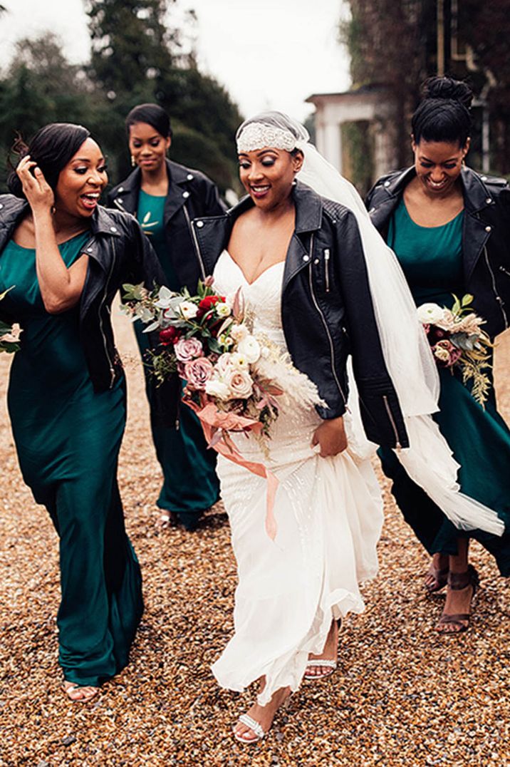 Bride in Juliet cap veil with leather jacket with bridesmaids in matching jackets for the wedding 