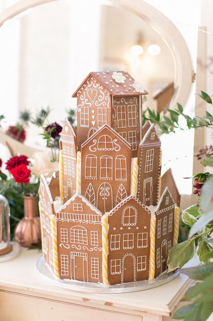 Christmas wedding cake idea with gingerbread house decorated with white icing and candy canes 