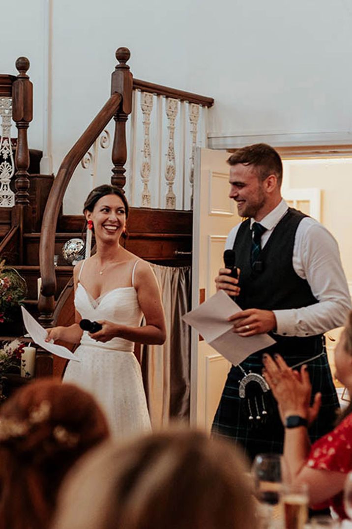 The bride and groom read out their joint wedding speech at barn wedding 