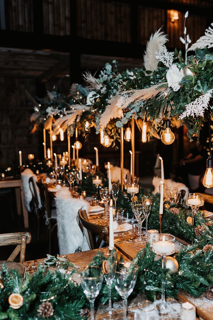 Christmas wedding with festive wedding tablescape with festoon lighting and pampas grass 