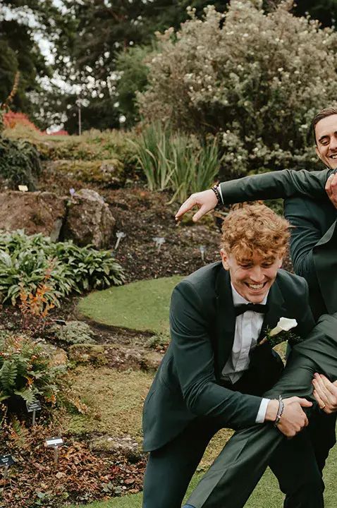 Groom and groomsmen wearing green suits by Cara Zagni Photography