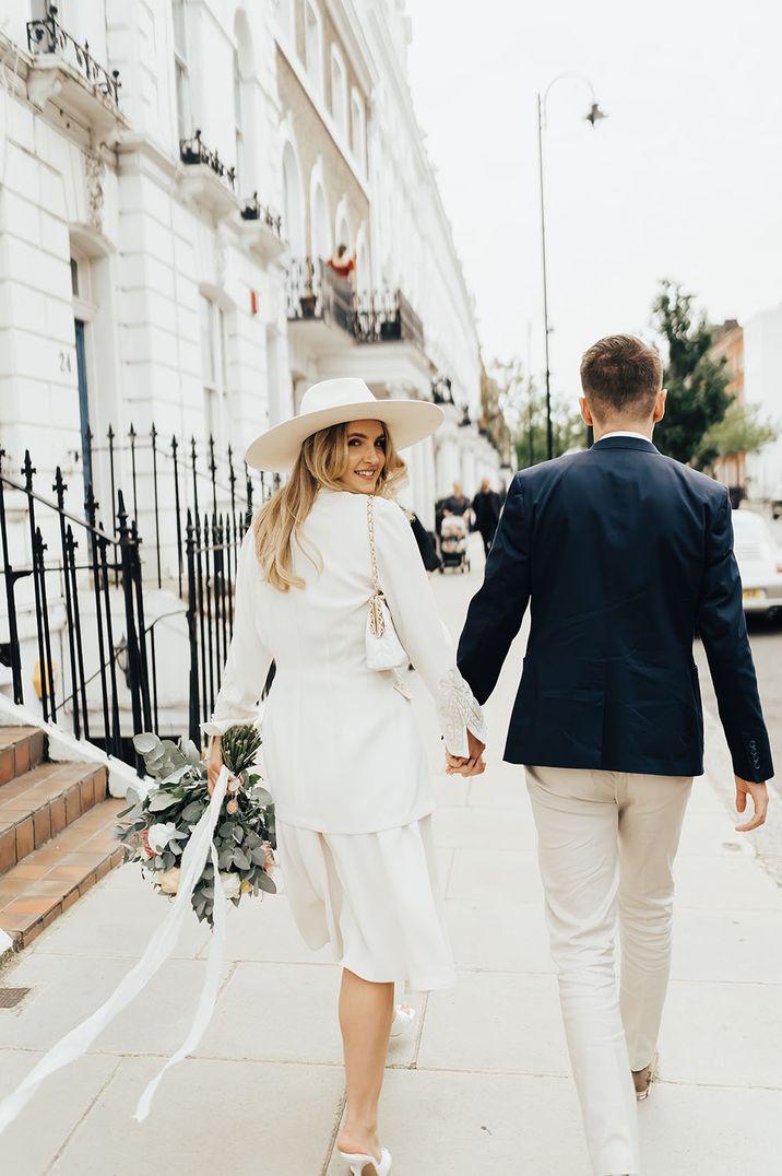 Intimate London wedding with bride in a vintage wedding suit belonging to her late mother and groom in a navy blazer 