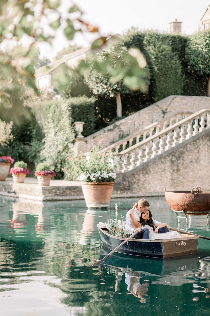 Bride and groom in canoe pictured on water at the boat house