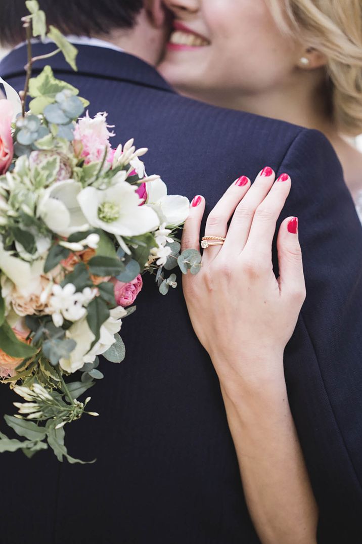 Pink wedding nails for bride with gold wedding and engagement ring 