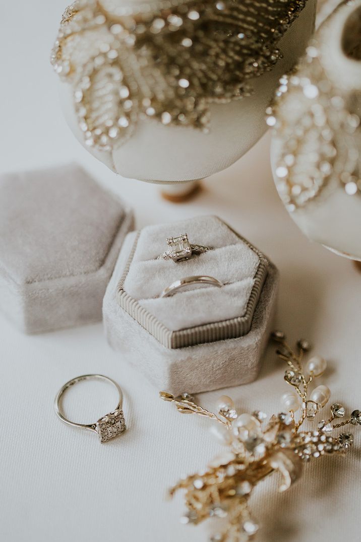 Grey velvet ring box with square diamond engagement ring and plain platinum wedding band 