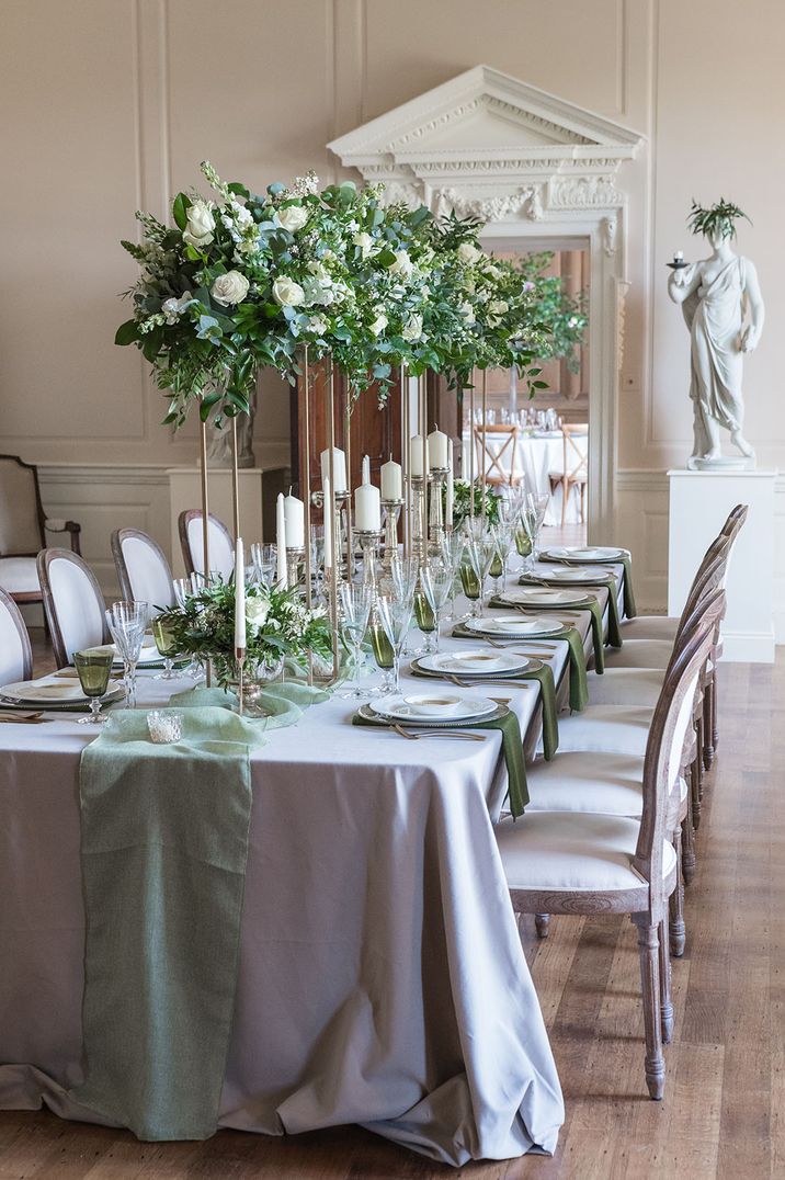 Sage green wedding theme colour palette and tablescape for country house wedding with tall white rose flower centrepieces 