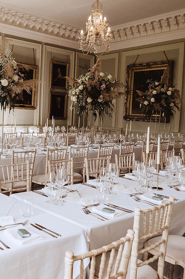 All white wedding tablescape with pampas grass and flower tall table centrepieces 