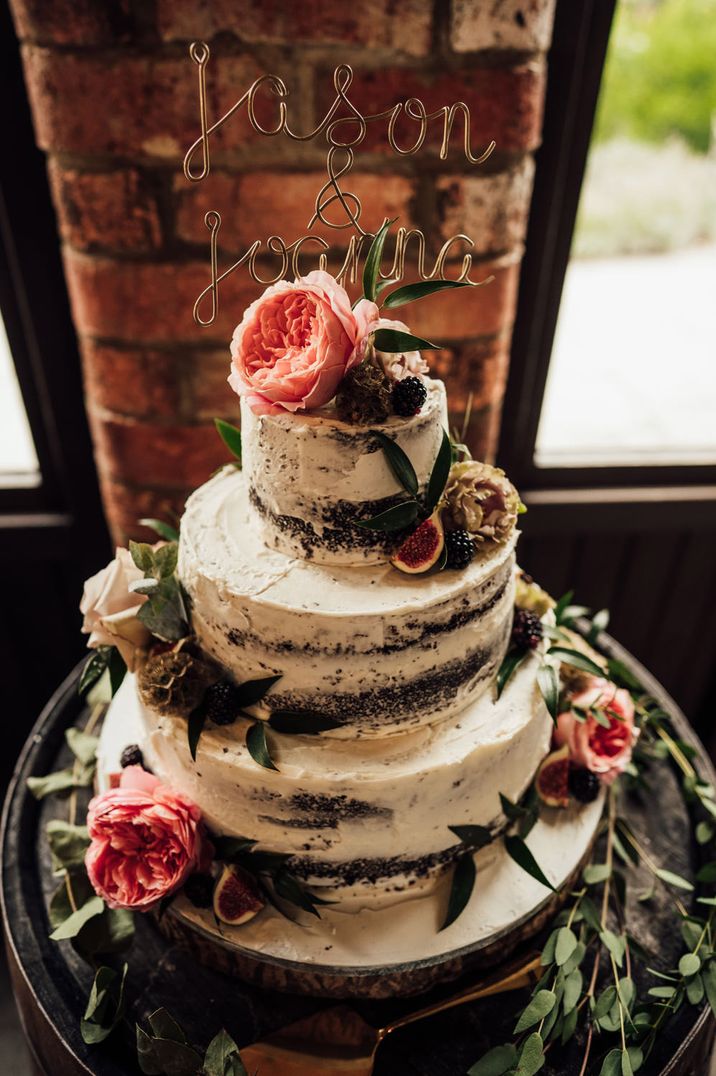 Semi-naked chocolate wedding cake decorated with flowers