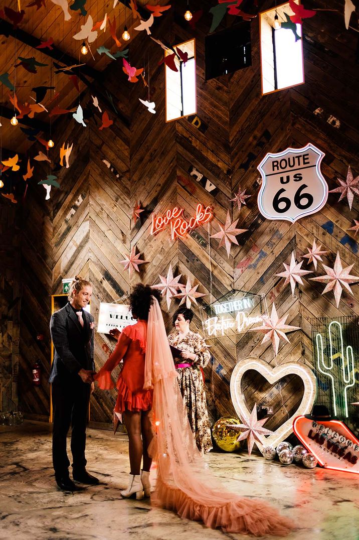 A neon rustic style wedding with lots of neon lights with Nat Raybould as the celebrant 