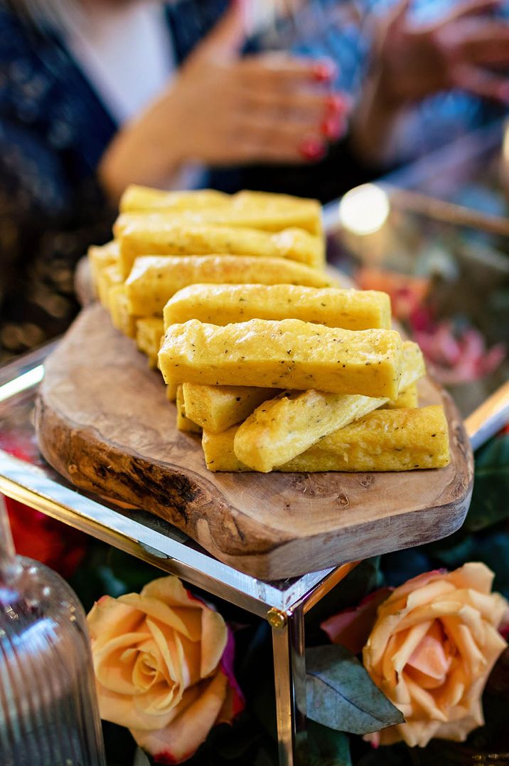 Truffle polenta chips on wooden sharing platter for wedding breakfast by Taste Caterer 