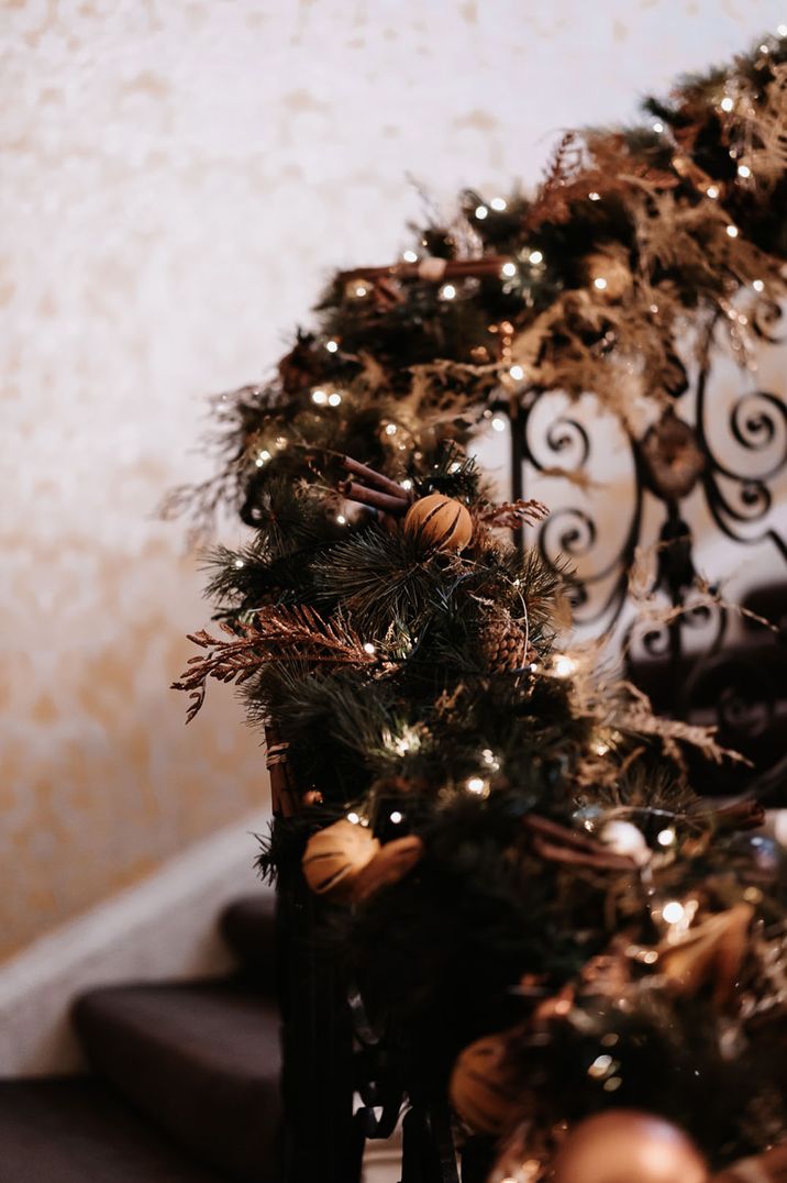 Festive winter wedding garland decorating the stairs at the wedding venue with cinnamon sticks 